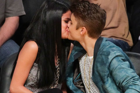 LOS ANGELES, CA - APRIL 17: Selena Gomez (L) and Justin Bieber kiss at a basketball game between the San Antonio Spurs and the Los Angeles Lakers at Staples Center on April 17, 2012 in Los Angeles, California.