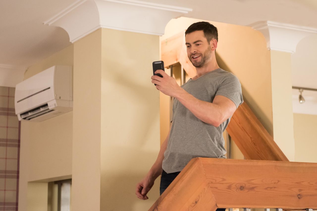 Cameron takes a photo of Lockie holding the petrol can